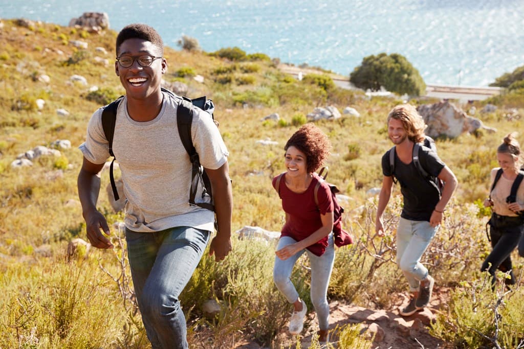 Group of friends hiking toward the coast